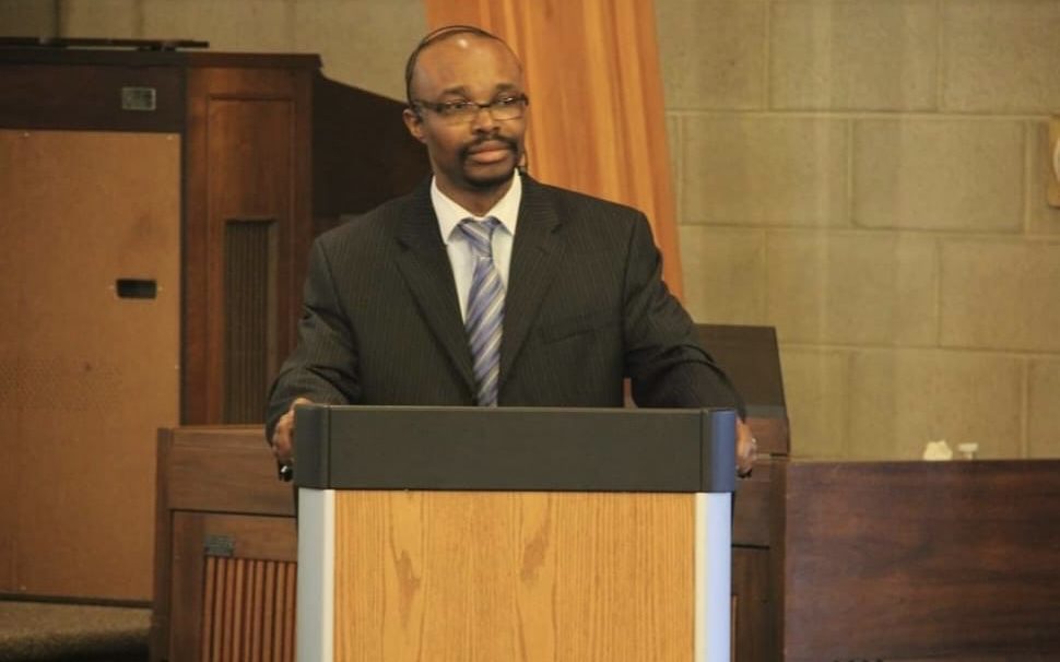 A speaker addressing the room from the podium